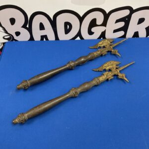 Antique iron fireplace poker with decorative handle.