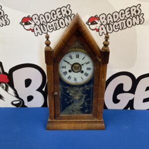 Antique Victorian mantle clock with arched wooden case.
