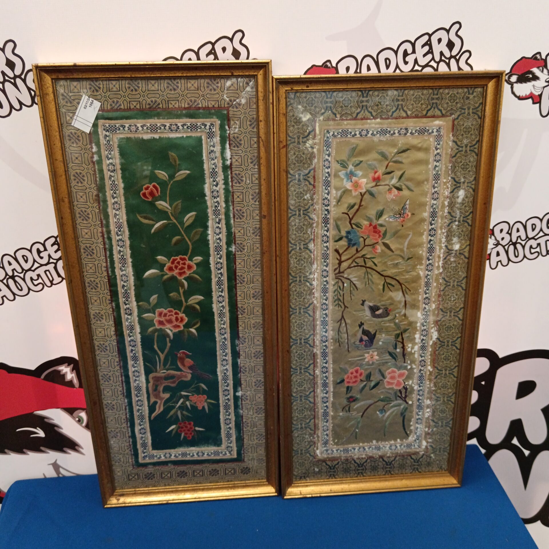 793 Pair of oriental silk embroideries of birds in trees in bloom