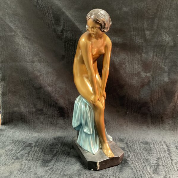 Vintage Art Deco plaster figure of a draped woman on a base.