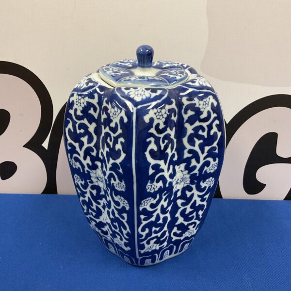 Antique blue and white ginger jar with floral pattern.