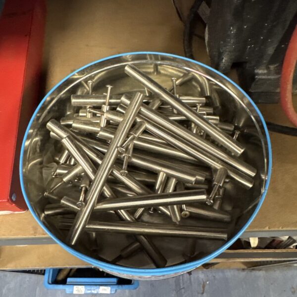 Large quantity of brushed steel drawer handles for cabinets and drawers.