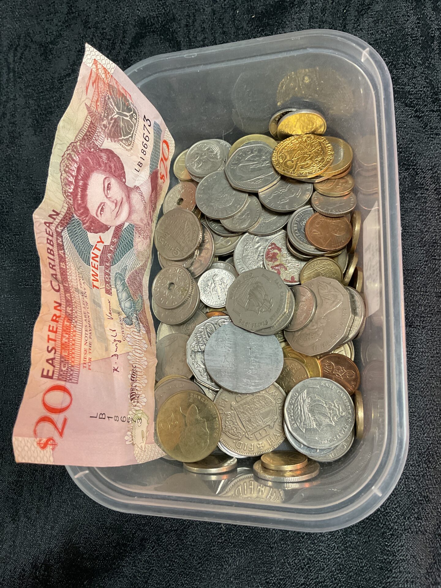 821 Tub mixed coins and a banknote