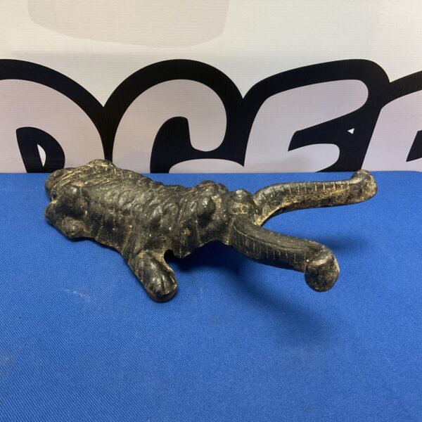 Vintage cast iron dog boot scraper for removing dirt.