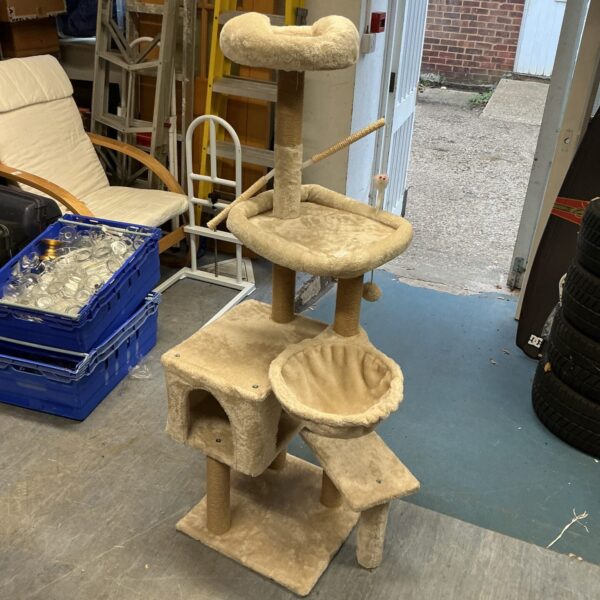 Beige multi-tiered cat play centre with scratching posts and platforms.