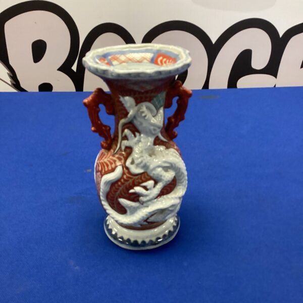 Antique Chinese porcelain vase with a detailed dragon design.
