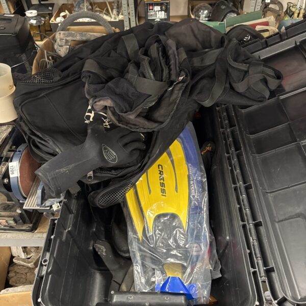 Large transit case filled with assorted scuba diving gear.