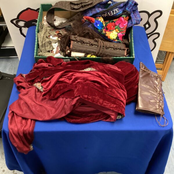 A colourful lot of fancy dress costumes including a hooded cape and corsets.