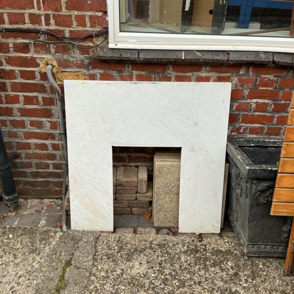 Antique cast iron fireplace insert with visible wear and rust.