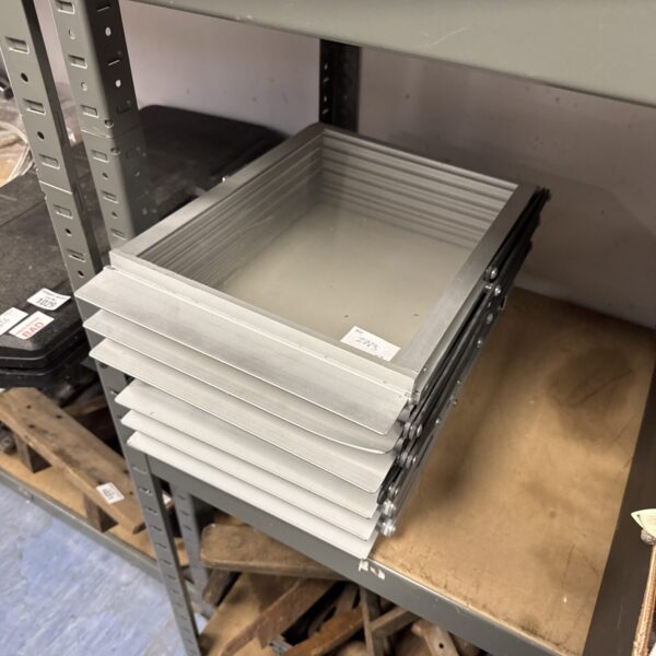 Silver folding A4 leaflet stand on a metal shelf.