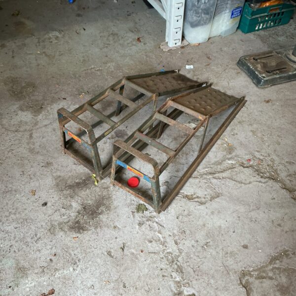 Set of used Halfords car ramps for vehicle maintenance.