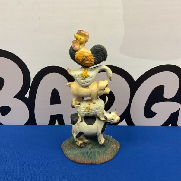 Vintage cast iron farm doorstop featuring a rooster and sheep.