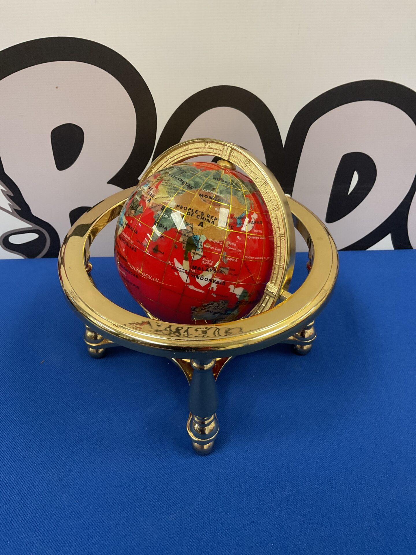 037 Small semi precious gemstone globe in brass stand
