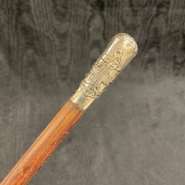 Detailed silver-coloured top of antique Boys Brigade swagger stick.