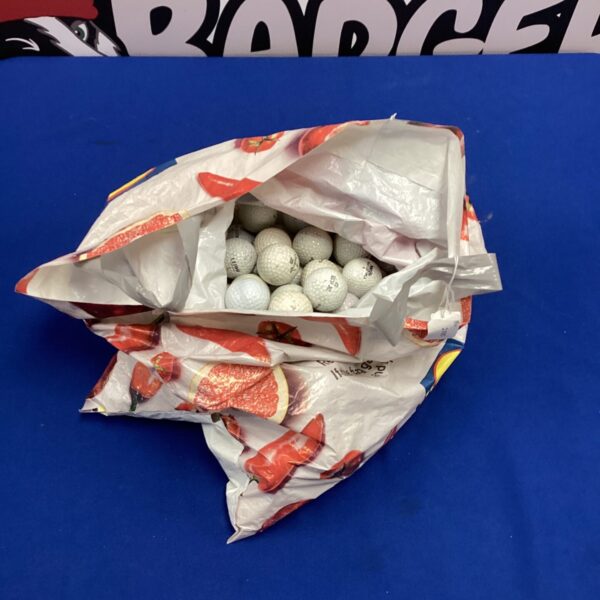 White used golf balls in a plastic bag, golf equipment.
