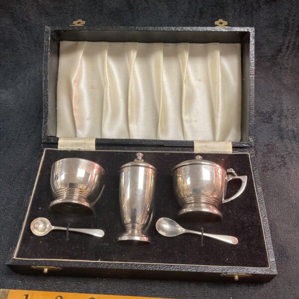 Antique sterling silver cruet set displayed in its original fitted case.
