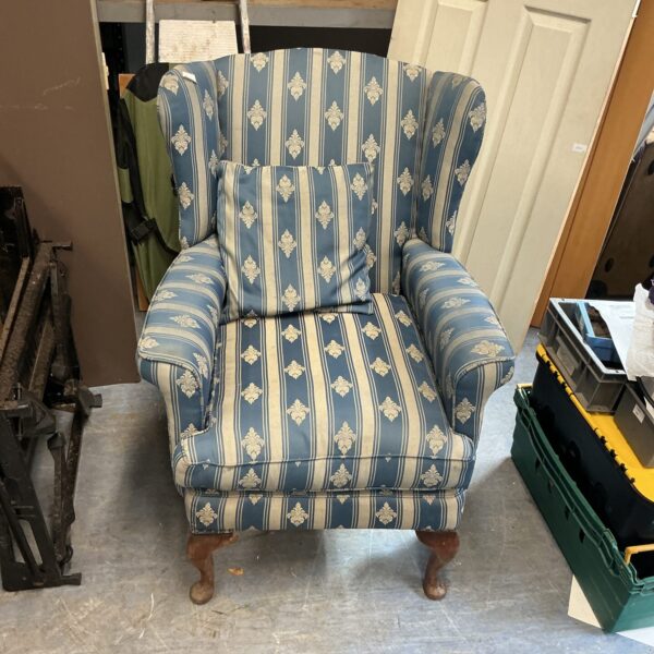 Vintage blue striped armchair with wooden legs.
