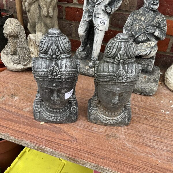 Pair of weathered stone Buddha head garden ornaments.