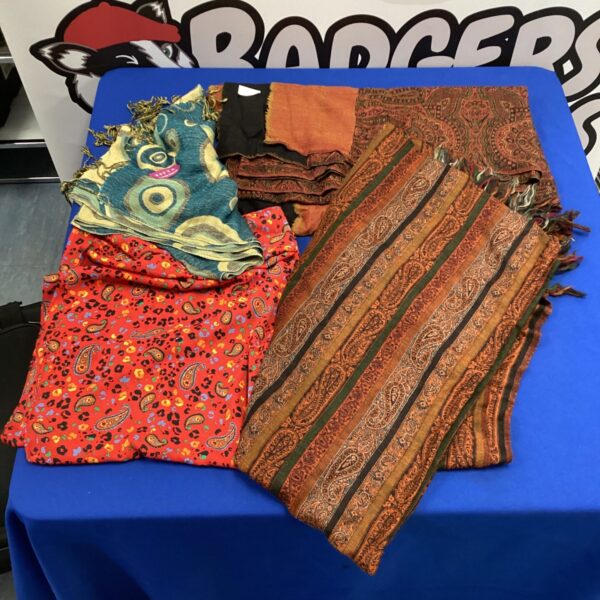 A lot of four colourful ladies scarves displayed on a blue background.