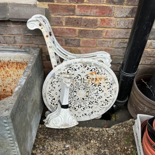 Intricate floral detailing on a vintage metal garden table.