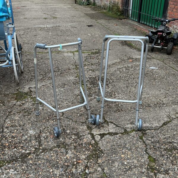 Pair of vintage walking frames for mobility assistance.
