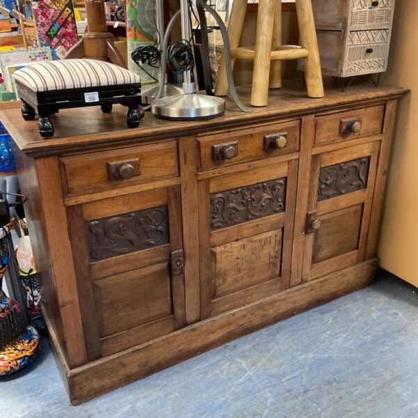 Antique Arts and Crafts sideboard with carved details.