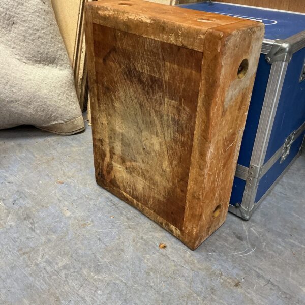 Vintage wooden butcher block with visible wear and texture.