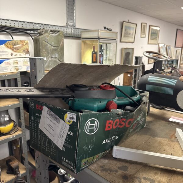 Bosch AKE 35 S electric chainsaw in used condition, side view.