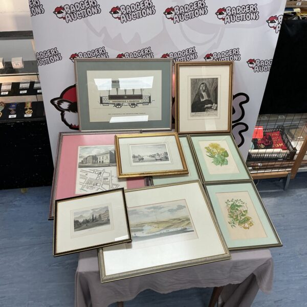 Assorted framed prints and artwork in a vintage collection.