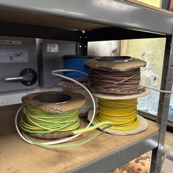 Partially used rolls of electrical cable for wiring projects.