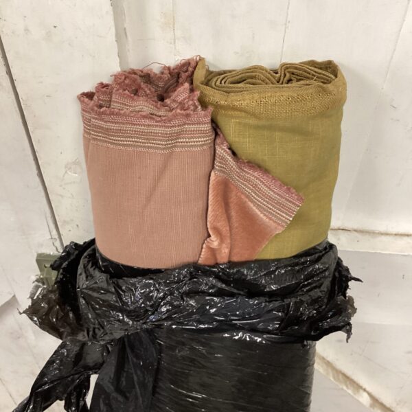 Vintage pink and green fabric rolls for crafting projects.