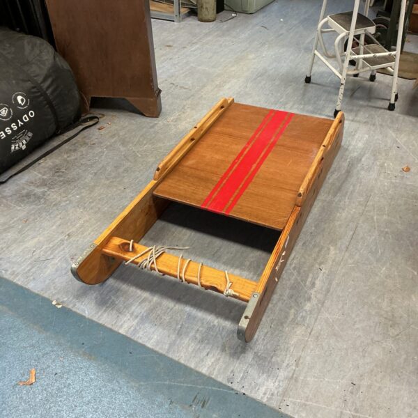 Large vintage wooden sledge for winter fun and rustic decor.