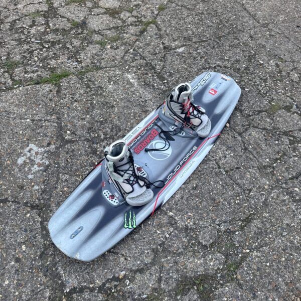 Blue Liquid Force Omega wakeboard with black bindings on asphalt.