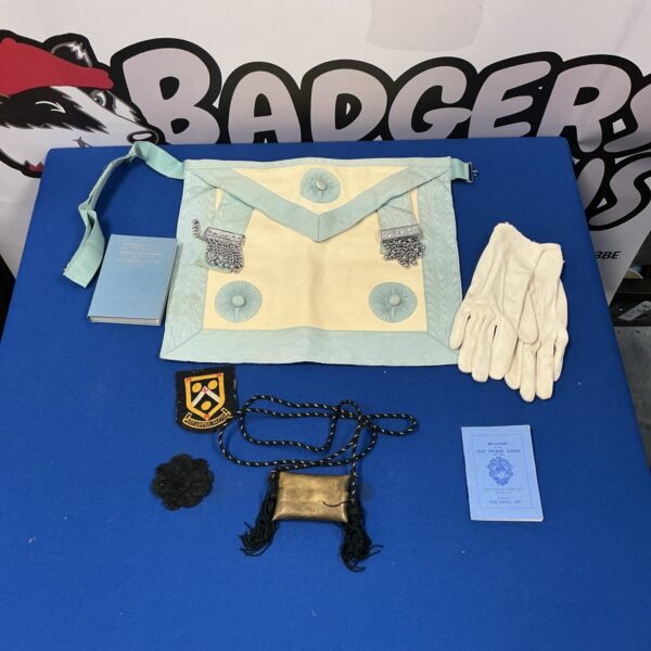 Vintage Masonic apron and regalia set with embroidered symbols.
