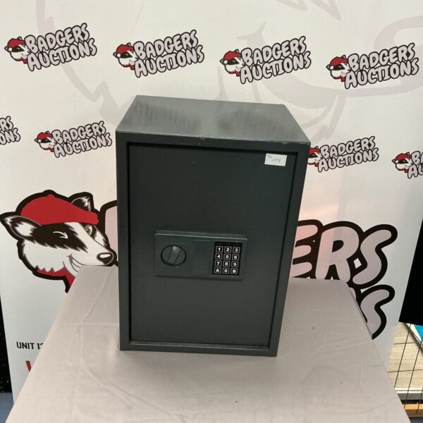 Vintage metal safe with combination and key lock for secure storage.