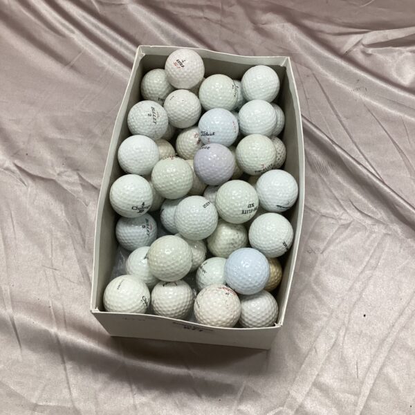 Mixed lot of used golf balls including Titleist for practice.