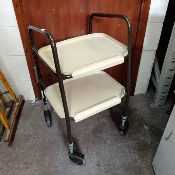 Side view of a vintage mobility walker trolley with three tiers.