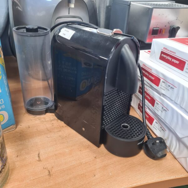 Sleek black Nespresso Magimix coffee machine for home brewing.