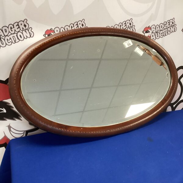 Vintage oval painted picture frame for wall display.