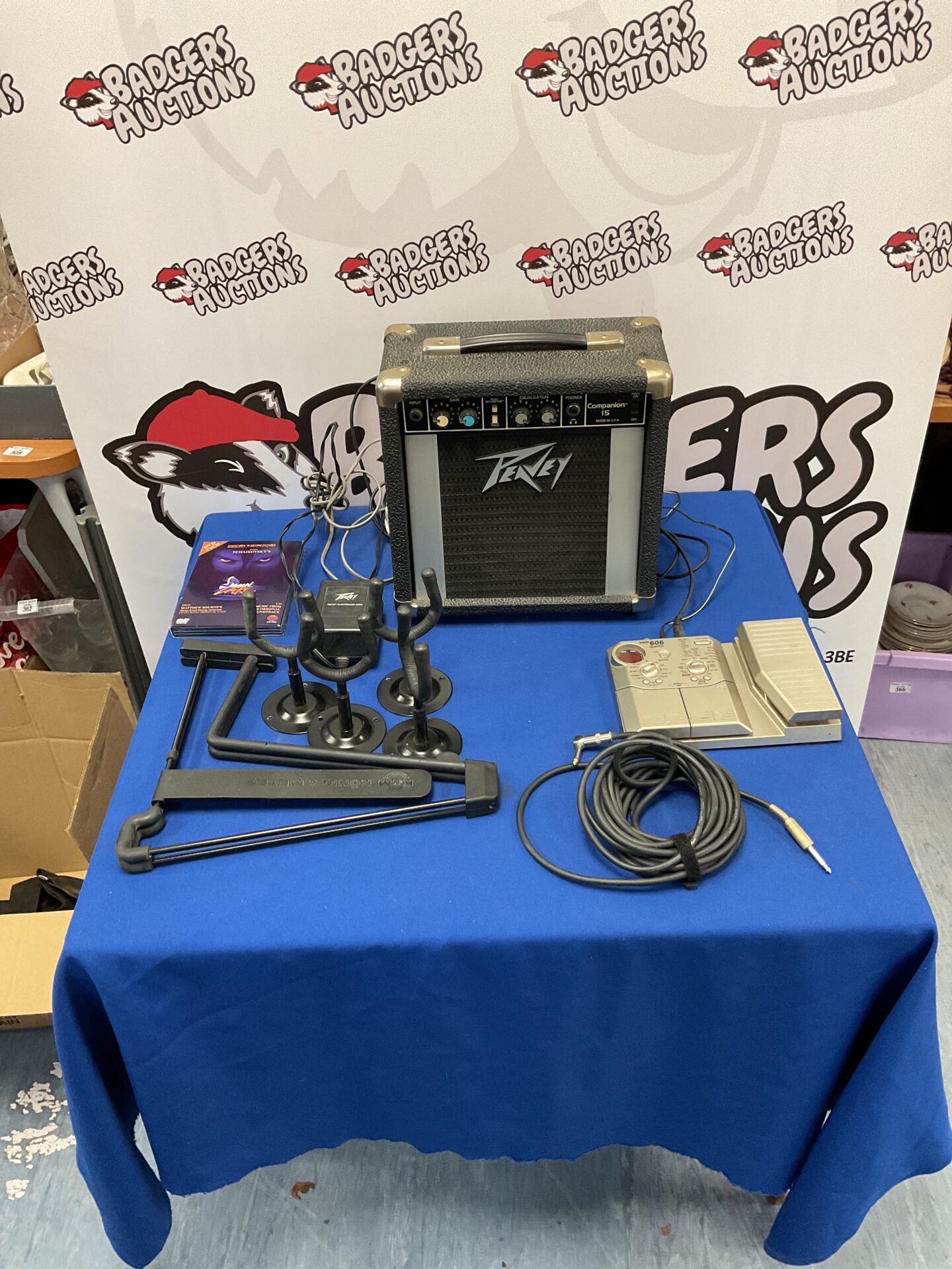 159 Box of mixed guitar items inc Peavey Companion 15 amp, brackets and stands, Zoom 606 guitar pedal