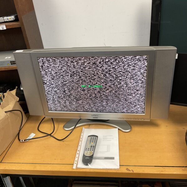 Front view of a working Saisho 26” TV with remote.