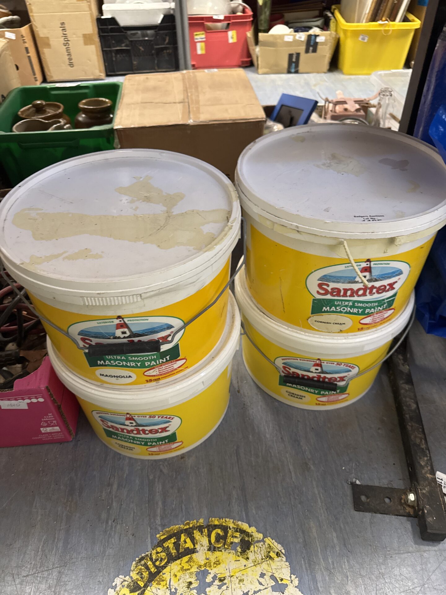 1105 Four tubs of assorted sandtex paint – some part used but mostly full