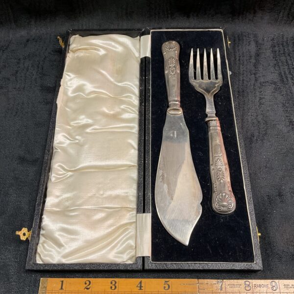 Vintage silver plate fish server set displayed in its lined box.
