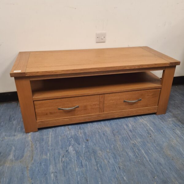 Solid oak media cabinet with two drawers for living room storage.