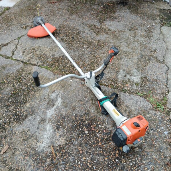 Used Stihl petrol grass strimmer for garden maintenance.
