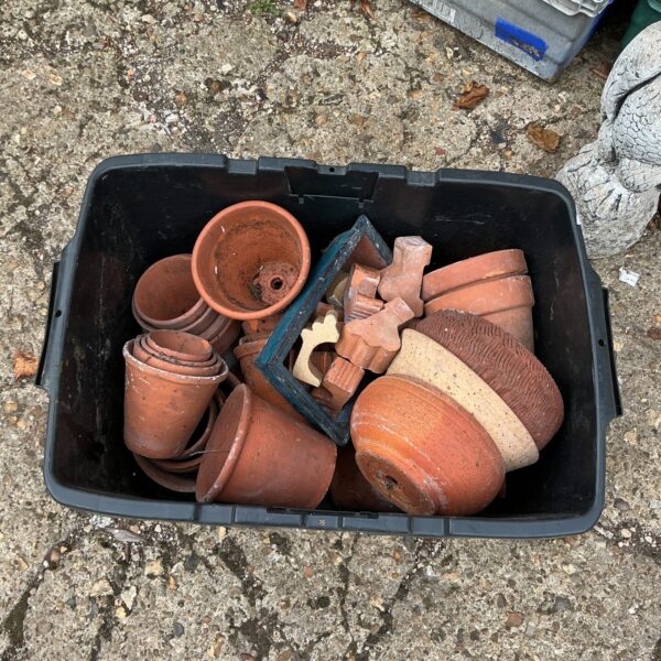 Mixed lot of weathered terracotta garden pots and planters.