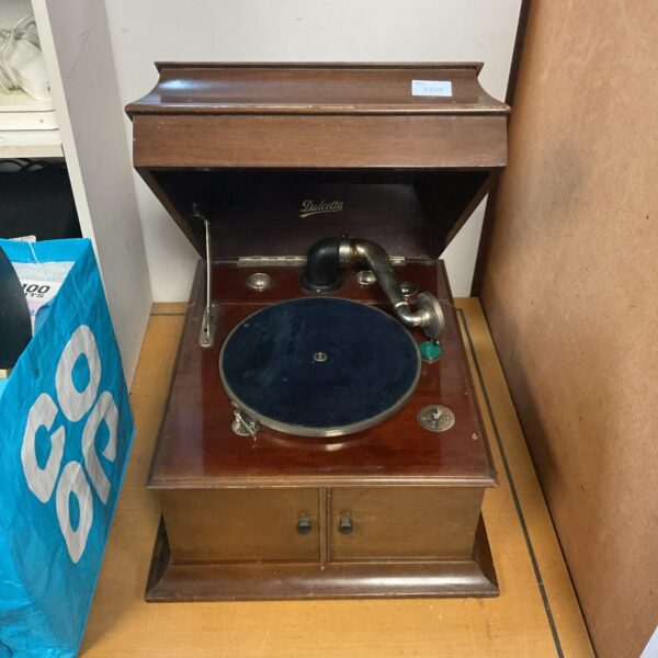 Vintage gramaphone with wooden cabinet and metal horn.