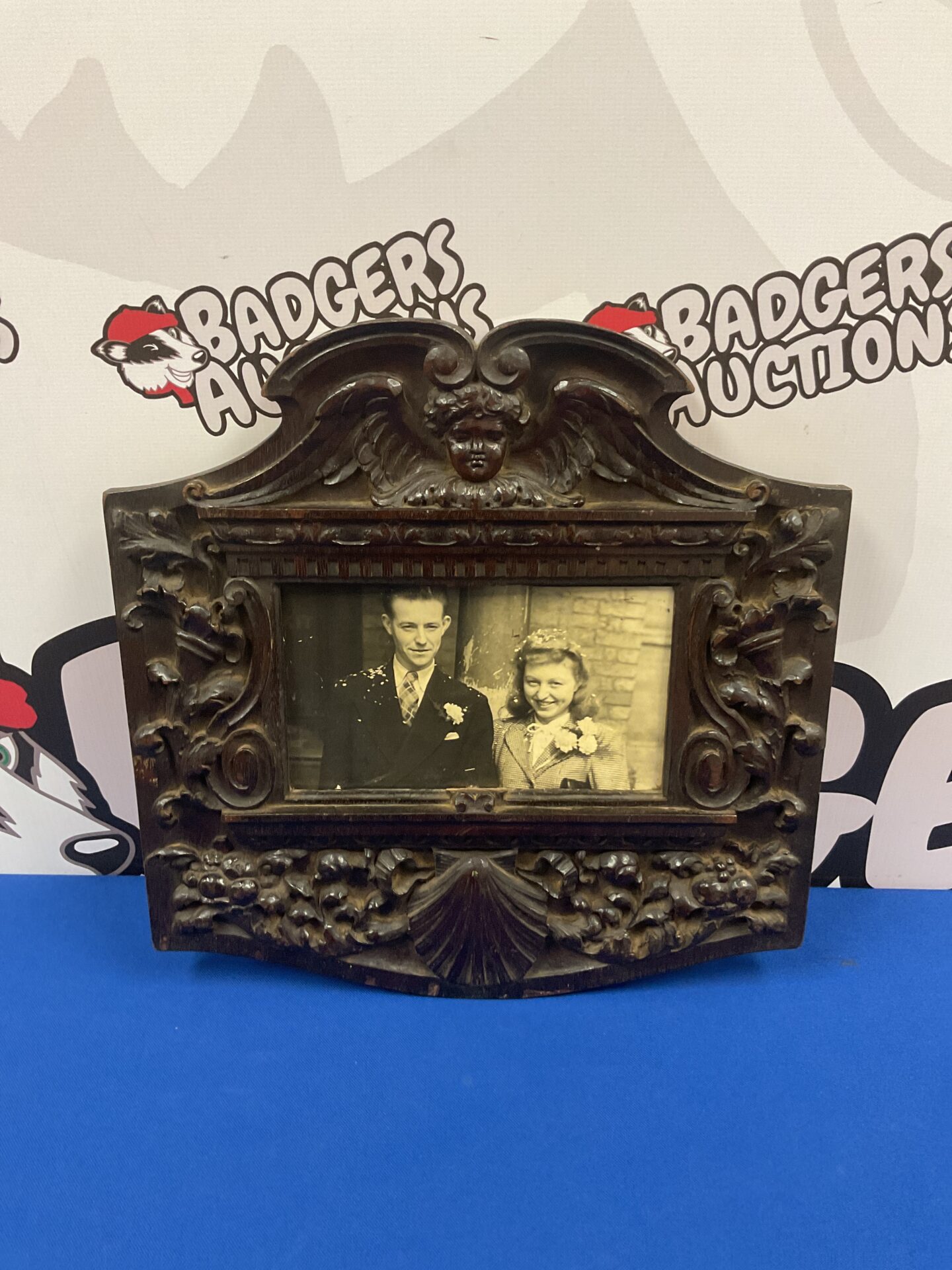 Ornate vintage photo frame with a portrait inside.