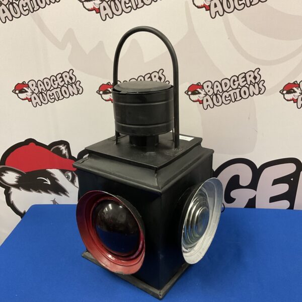 Vintage railway lantern with glass lenses, a classic railroad signal lamp.