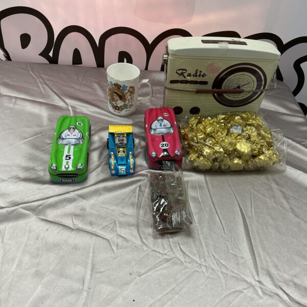 Vintage tin sweet containers shaped like colourful cars.